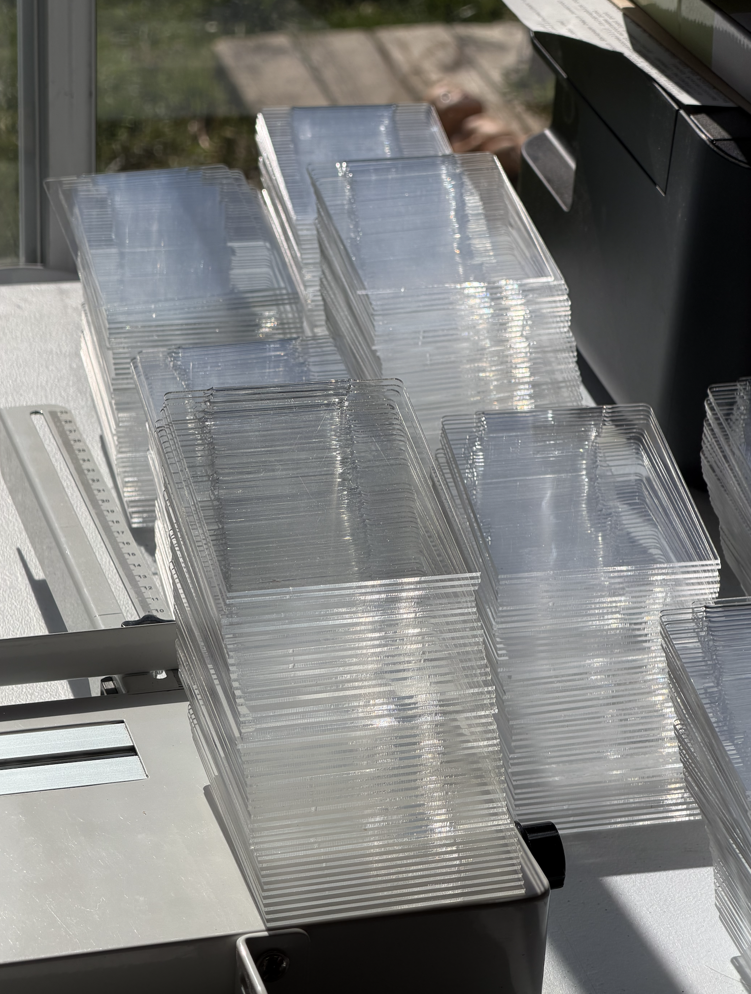 Stacks of freshly fabricated clear acrylic shelf talkers ready for packing at Prince Fabrication